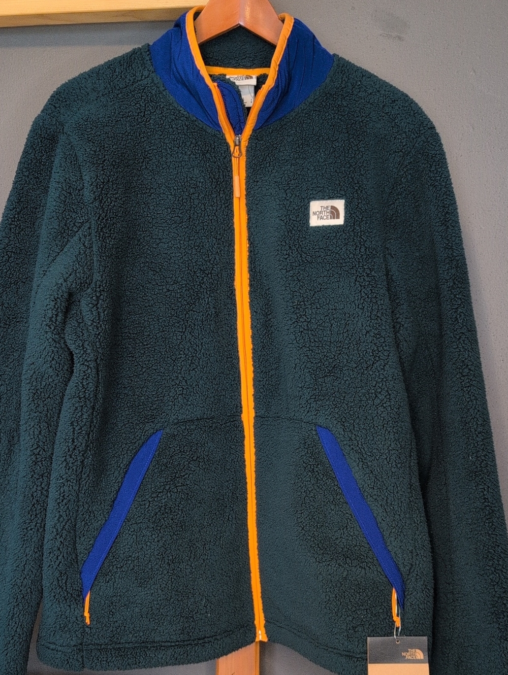 The North Face Dark Teal Sherpa Jacket with Orange Zip and Blue Accents
